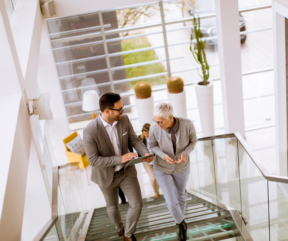 Photo of two people walking upstairs in a gym