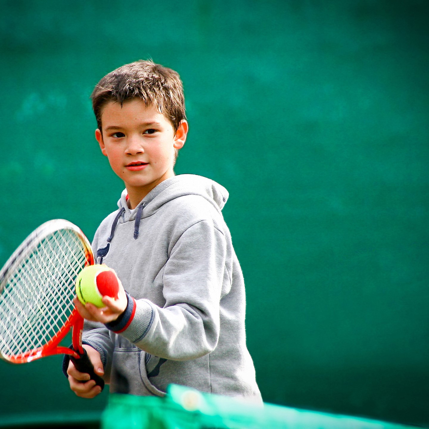 A young boy playing tennis