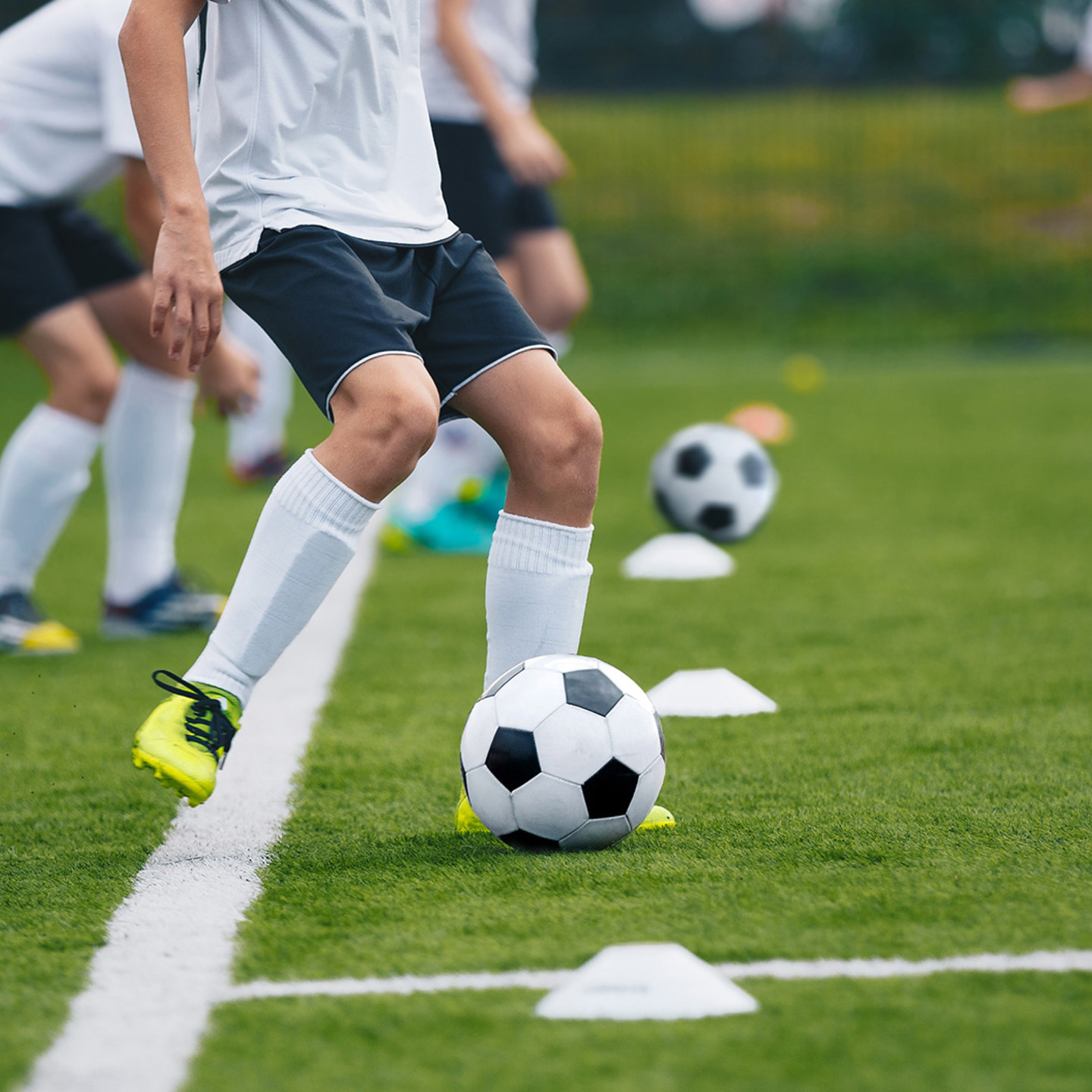 Group of men playing football on grass